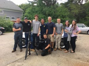 Joe Kingsland and his students pose with the TV crew from New England Cable News.